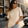 "Woman wearing oversized cream cotton t-shirt with brown cargo pants, minimal casual outfit"