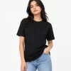 Woman wearing classic black cotton t-shirt with blue denim jeans, casual everyday outfit