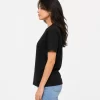 Woman wearing classic black cotton t-shirt with blue denim jeans, casual everyday outfit