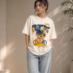 Woman wearing cream oversized t-shirt with Creative Smile teddy bear streetwear graphic print