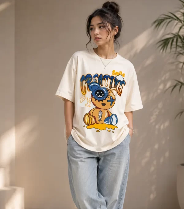Woman wearing cream oversized t-shirt with Creative Smile teddy bear streetwear graphic print