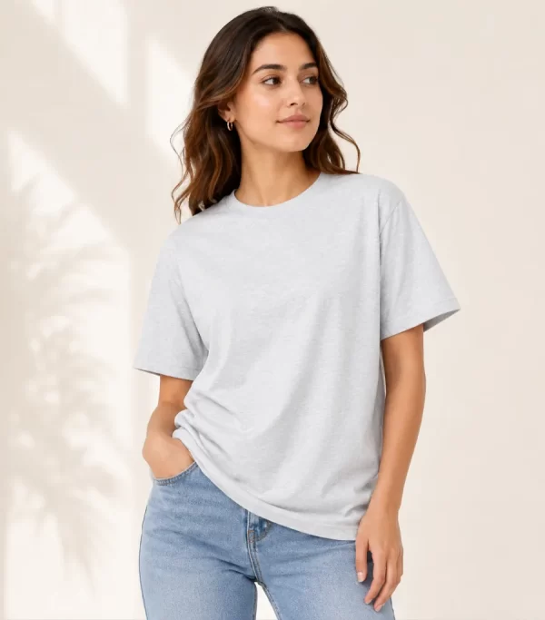 Woman wearing heather grey cotton t-shirt with blue denim jeans, casual everyday outfit