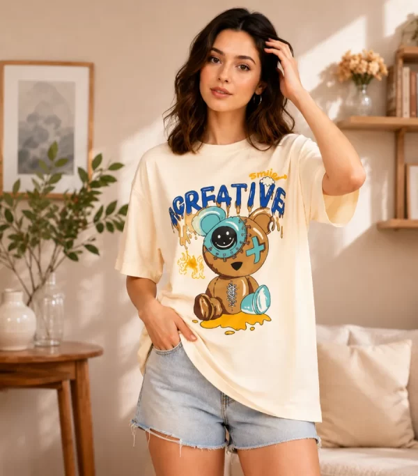 Woman wearing cream oversized t-shirt with Creative Smile teddy bear streetwear graphic print