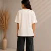Woman wearing cream oversized t-shirt with Creative Smile teddy bear streetwear graphic print