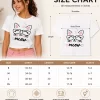 Woman wearing white cropped t-shirt with printed cat face "meow" graphic design and pink heart print, paired with blue jeans