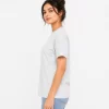 Woman wearing heather grey cotton t-shirt with blue denim jeans, casual everyday outfit