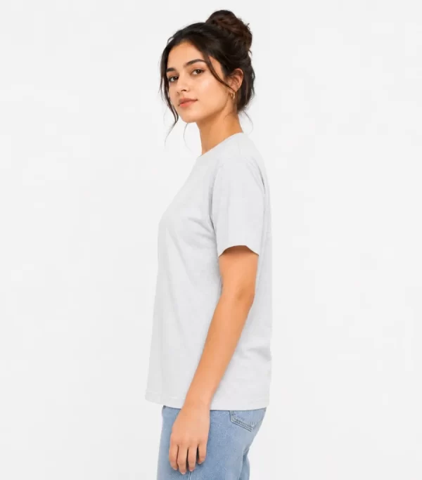 Woman wearing heather grey cotton t-shirt with blue denim jeans, casual everyday outfit