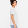 Woman wearing heather grey cotton t-shirt with blue denim jeans, casual everyday outfit