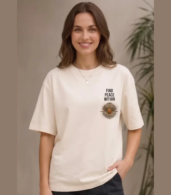 Woman wearing beige oversized t-shirt with Japanese ink-style mountain and red sun print on back, 'Find Peace Within' text with medallion graphic on front