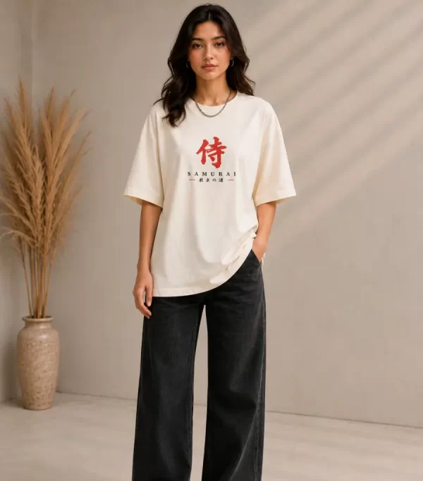 Woman wearing beige oversized Samurai graphic t-shirt with red Japanese kanji print, paired with black wide-leg jeans front and back view