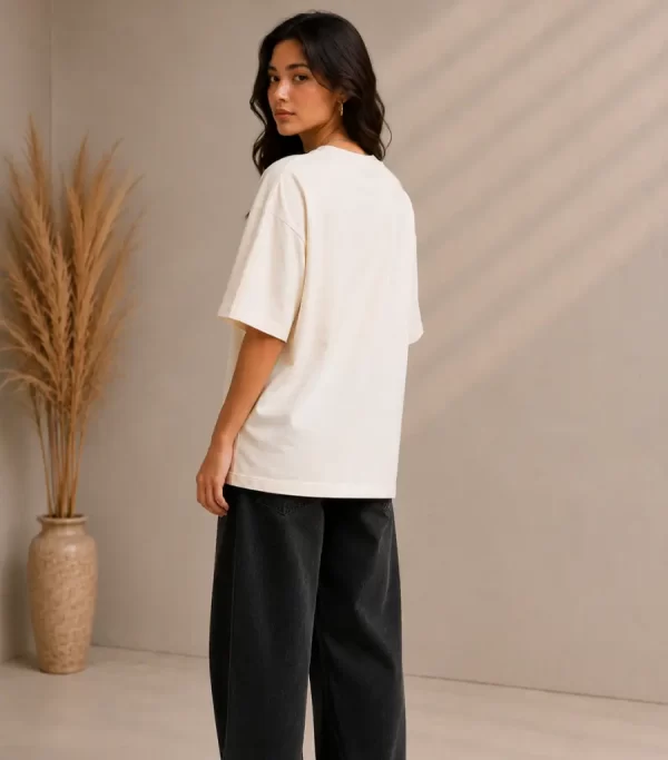 Woman wearing beige oversized Samurai graphic t-shirt with red Japanese kanji print, paired with black wide-leg jeans – front and back view