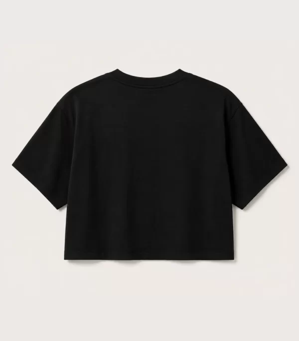 Woman wearing black oversized cropped t-shirt with boxy fit, paired with white jeans