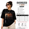 Woman wearing oversized black graphic T-shirt with white shorts