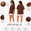Woman wearing oversized brown cotton t-shirt with white shorts and sneakers, casual streetwear outfit
