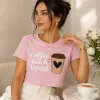 Woman wearing pink Coffee Teach Repeat graphic t-shirt with coffee cup design, ideal teacher gift tee