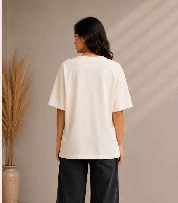 Image 1 (Front View) Women's oversized white graphic printed cotton t-shirt front view with abstract colorful face print. Image 2 (Side View) Women's white oversized graphic t-shirt side profile featuring modern abstract print and relaxed fit. Image 3 (Back View) Women's oversized white cotton t-shirt back view showing plain design with half sleeves and relaxed fit. Image 4 (Angled View) Women's oversized white graphic print t-shirt angled view with premium cotton fabric and casual streetwear style.