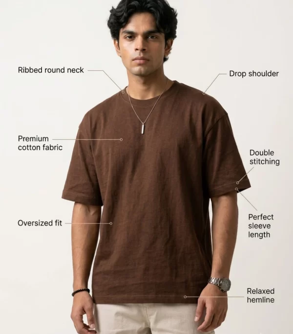 Man wearing brown oversized t-shirt with cream cargo pants, sunglasses, and white sneakers in a minimal studio setting.